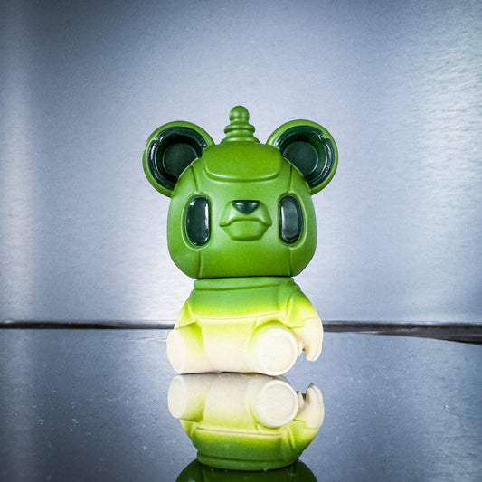 Green and white robot-like figure on a reflective surface with a gray background