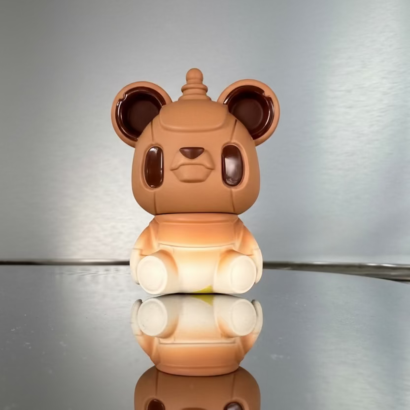 Brown teddy bear-shaped night light on a reflective surface